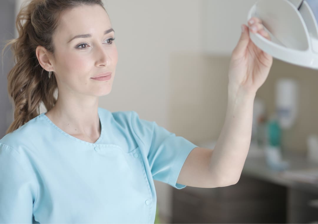 Doctor adjusting light in clinic