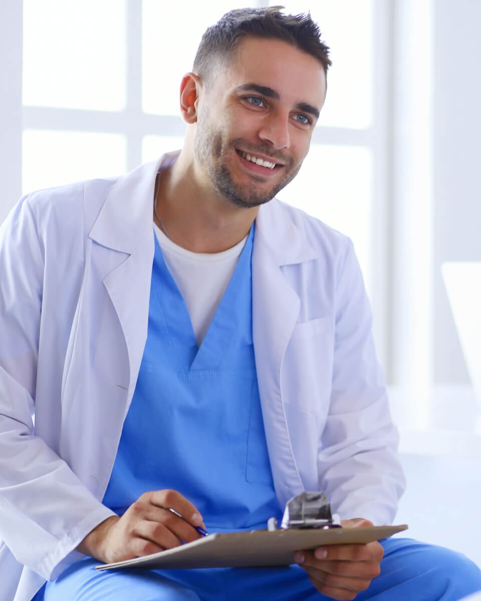 Smiling doctor holding a clipboard
